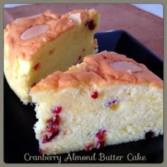 two slices of cranberry almond butter cake on a black plate