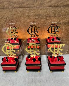 four red and black boxes with gold letters on them