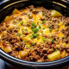 a crock pot filled with ground beef and potatoes