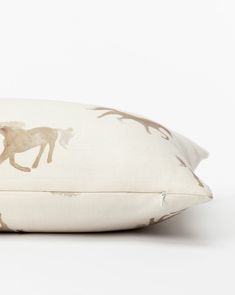 a white pillow with a horse print on it