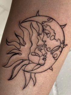 a tattoo on the leg of a woman with a sun and moon behind her head