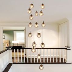 a chandelier hanging from the top of a stair case