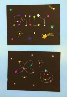 two black paper cards with stars and the word's name written in white chalk