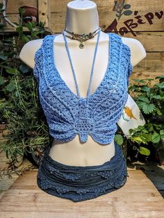 a mannequin wearing a blue crochet top