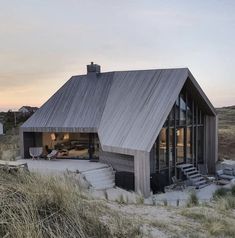 the house is made out of wood and has a pitched roof