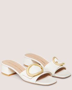 BENNI 35 SLIDE | Stuart Weitzman Elegant Formal Mules With Rectangular Buckle, Block Heels With Rectangular Buckle Closure, Elegant White Block Heels With Buckle Closure, White Block Heels With Buckle Closure, White Mules With Buckle Closure For Formal Occasions, Elegant Block Heels With Buckle Closure, Elegant Square Toe Mules With Buckle Closure, Luxury Low Heel Mules With Buckle Closure, Formal Flat Heel Mules With Buckle Closure