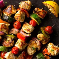 chicken and vegetable kabobs on skewers with tomatoes, onions, peppers, and bananas