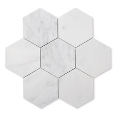 hexagon marble tile with white veining on the top and bottom, set against a white background