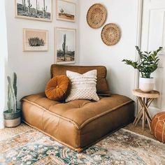 a living room filled with lots of pictures on the wall and a brown leather chair