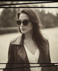 woman wearing round sunglasses and leather jacket