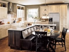 a kitchen filled with lots of counter space next to a dining room table and chairs