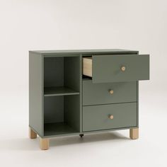 a green cabinet with two drawers and one drawer open on the bottom, in front of a white background