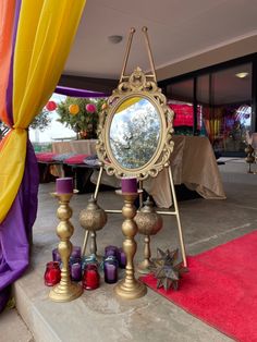 a mirror sitting on top of a table next to candles