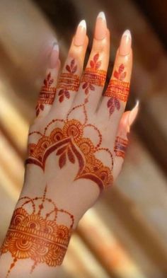 a woman's hand with henna on it