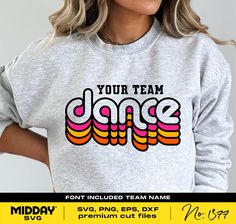 a woman wearing a sweatshirt that says your team dance on the front, and an image of