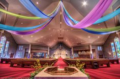 the interior of a church decorated with colorful streamers