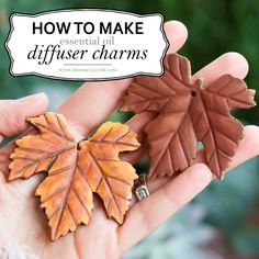 two small leaves in the palm of someone's hand with text overlay that says how to make essential oil diffuse charms