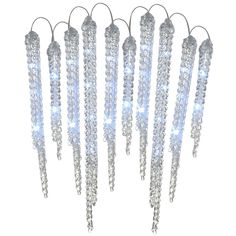 a group of silver and white chandelier hanging from strings with lights on them