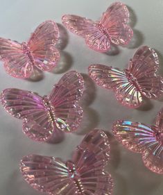 pink glass butterflies on a white surface