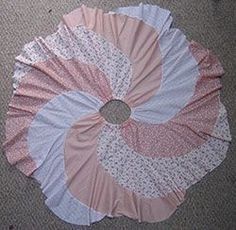 a pink and white frilly on the floor in front of a carpeted area