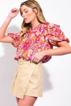 A printed woven top featuring ruffled neckline with tie/tassel and puff sleeve with ruffle over shoulder Details: Self : 85% RayonLining: 15% Nylon Size & Fit - Model is 5`8" And Wearing Size Small- Measurements Taken From Size Small- Approx. Length: 23 3/4" Printed Blouse With Ruffle Sleeves, Multicolor Balloon Sleeve Puff Top For Summer, Pink Puff Sleeve Top With Gathered Sleeves For Summer, Multicolor Printed Puff Sleeve Blouse, Chic Printed Blouse With Balloon Sleeves, Multicolor Puff Sleeve Top With Gathered Sleeves, Multicolor Blouse With Gathered Sleeves, Pink Balloon Sleeve Blouse With Ruffles, Multicolor Tops With Gathered Sleeves For Spring