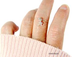 "This cute flower charm dangle ring has a sterling silver dainty flower, color of your choice, with Swarovski crystal rhinestones dangling from the sterling silver argentium band. ✦100% handcrafted ✦ High quality sterling silver and sterling silver argentium ✦ Arrives in a beautiful pink or white cotton-filled gift box with and tied with a pink or black bow and an optional complimentary pastel colored gift card ✦ Ready to ship in one business day ✦ Average shipping time (US/Canada/UK) three to f Delicate Flower Birthstone Promise Ring, Dainty Sterling Silver Diamond Ring Gift, Adjustable Birthstone Flower Ring For Anniversary, Adjustable Flower Ring With Birthstone For Anniversary, Dainty Birthstone Flower Ring For Anniversary, Delicate Cubic Zirconia Flower Ring For Gifts, 14k Gold Flower Ring As A Gift, Dainty Flower Ring With Birthstone For Anniversary, Diamond Flower Ring With Birthstone As A Gift