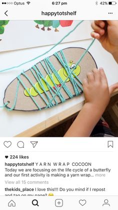 a kid is making a craft with string and glue on the back of a skateboard