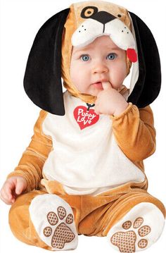 a baby in a dog costume sitting on the floor with his hand under his chin