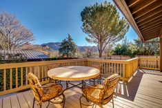 a table and chairs on a wooden deck