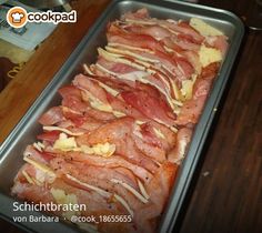 bacon is being cooked in a pan on the counter top, ready to be baked