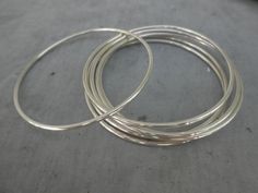 "This is a set of 7 handmade solid 925 sterling silver bangles. This bangles are hand forged with 12ga (about 2mm) round wire. -------------- SHIPPING: FREE Domestic Shipping! This item will be shipped insured by USPS First Class Mail in the USA, and Insured First class International Mail for International orders. ------------------ HOW TO MEASURE ? If you do have any bangle at home you can measure the inner diameter. If you don't I suggest you to measure your hand this way: Close your fingers t Necklace Outfit, Sterling Silver Bangle Bracelets, Nail Tattoo, Sterling Silver Bangle, Indian Attire, Diy Crafts Jewelry, Silver Bangle Bracelets, Sterling Silver Bangles, Silver Bangle