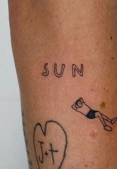 a person has a tattoo on their leg that says sun