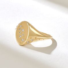 Elevate your style with the Diamond Celestial Signet Ring. This 14k solid gold flat dome ring for women features a stunning star and moon constellation design adorned with diamonds. The chunky design and celestial inspiration make it a unique and captivating piece. Choose from 18k or 10k gold for your preferred look. Features * Made to Order. * Gold KT: 10K, 14K, 18K * Custom Gold Color: Rose Gold, Yellow Gold, White Gold * Diamond Color- Clarity: D-E-F color VVS clarity (excellent ideal cut) * Total Ctw: 0.09 ctw * Width of Top: 12.50x8.20MM * Width of Band: 1.33MM * Thickness of Band: 0.80MM * Ready to Ship in 5-7 Business Days ✓ We care about the environment,the jewelry we cast is made with recycled gold. We source exclusively post-consumer material that is refined back to its pure elem Signet Rings Women Vintage Diamond, Unique Signet Ring, Moon Constellation, Celestial Inspiration, Pinky Rings For Women, Constellation Design, Pinky Signet Ring, Constellation Ring, Signet Rings Women