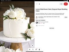 a cake with white flowers on top is displayed in an instagram page for the bride and groom