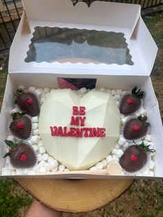 a heart shaped cake with chocolate covered strawberries in a box that says be my valentine