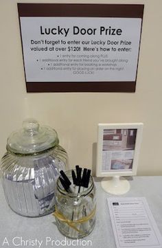 there is a glass jar with pens in it and a sign on the wall behind it