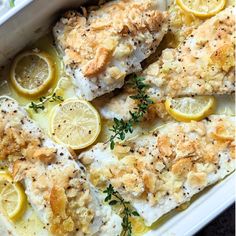 baked fish with lemons and herbs in a casserole dish