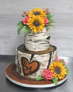 the cake is decorated with sunflowers and leaves