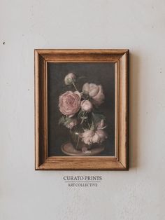 a painting hanging on the side of a wall with flowers in it's vase