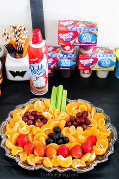 a fruit and veggie platter is displayed on a table with other snacks