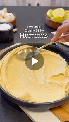 a pan filled with hummus on top of a table