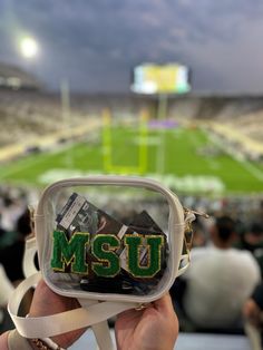 ★ MSU Stadium bag, perfect for sports games and tailgating ★ Show your team spirit with your team's colors! ★ Size: 7.8" X 5.8" X 1.9" ★ Pass through security quickly Introducing our Personalized Clear Stadium Jelly Bag, a game day bag that's perfect for sporting events, and large-scale gatherings. This transparent bag is made from high-quality PVC material that's both durable and lightweight. It comes with an adjustable crossbody strap that adds convenience and comfort to your every wear. Diy Stadium Bag, Stadium Approved Bags, Clear Bags For Football Games, Clear Purses For Football Games, Diy Clear Stadium Purse, Concert Purse, Stadium Bags Clear, Clear Game Day Purses, Game Day Bag