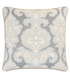 a gray and white pillow with an ornate design on the front, along with a beige border