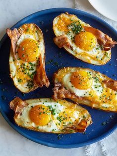 an image of eggs in the middle of bread on a blue plate with parsley