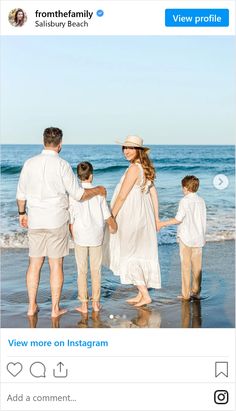 the family is standing on the beach together