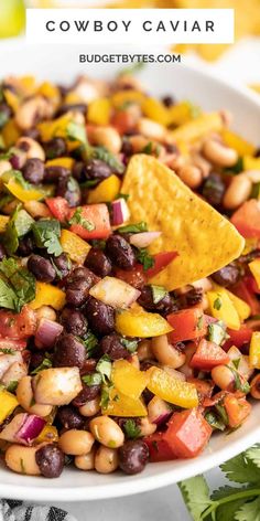 a white bowl filled with black - eyed beans, corn and avocado salsa