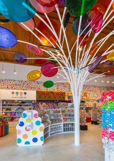 the inside of a store with balloons hanging from the ceiling and decorations on the walls