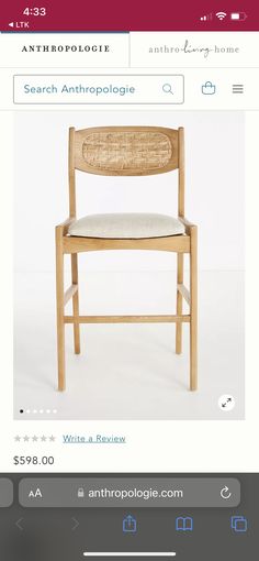 a wooden chair with a white seat and back cushion is on the web page for anthropoloie com