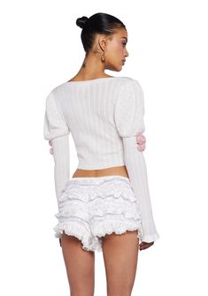 cuz you are admired by all. This long sleeve top has a soft pointelle knit construction, long sleeves with puffed shoulders and ruffled cuffs, fabric rosette appliques on the bust and sleeves, and a cropped fit. Feminine Long Sleeve Ruffled Sweater, Feminine Puff Sleeve Tops For Winter, Feminine Puff Sleeve Winter Tops, White Ruffled Sweater For Spring, Feminine Winter Puff Sleeve Tops, Fitted White Sweater With Ruffles, Feminine Fitted Sweater With Ruffles, Fitted Ruffle Sweater Feminine Style, Fitted Feminine Ruffle Sweater