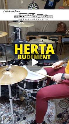 a man sitting in front of a drum set with the words hereta rudiment on it